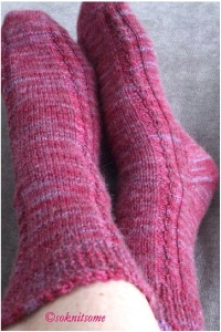 pink cabled socks possum wool feet crossed