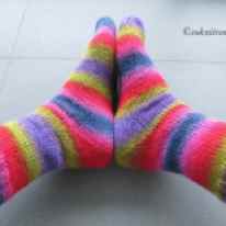 bright striped socks on feet - side view