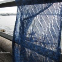 blue lace wrap with sea in background