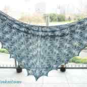 turquoise lace shawl hanging in front of window