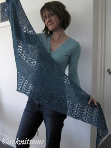 Woman holding blue lace scarf