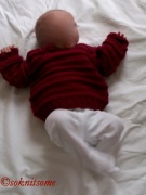 Baby wearing red jumper