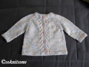 Baby cardigan with cables and little pink buttons