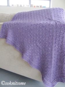 Purple textured baby blanket - draped