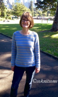author in striped jumper in park